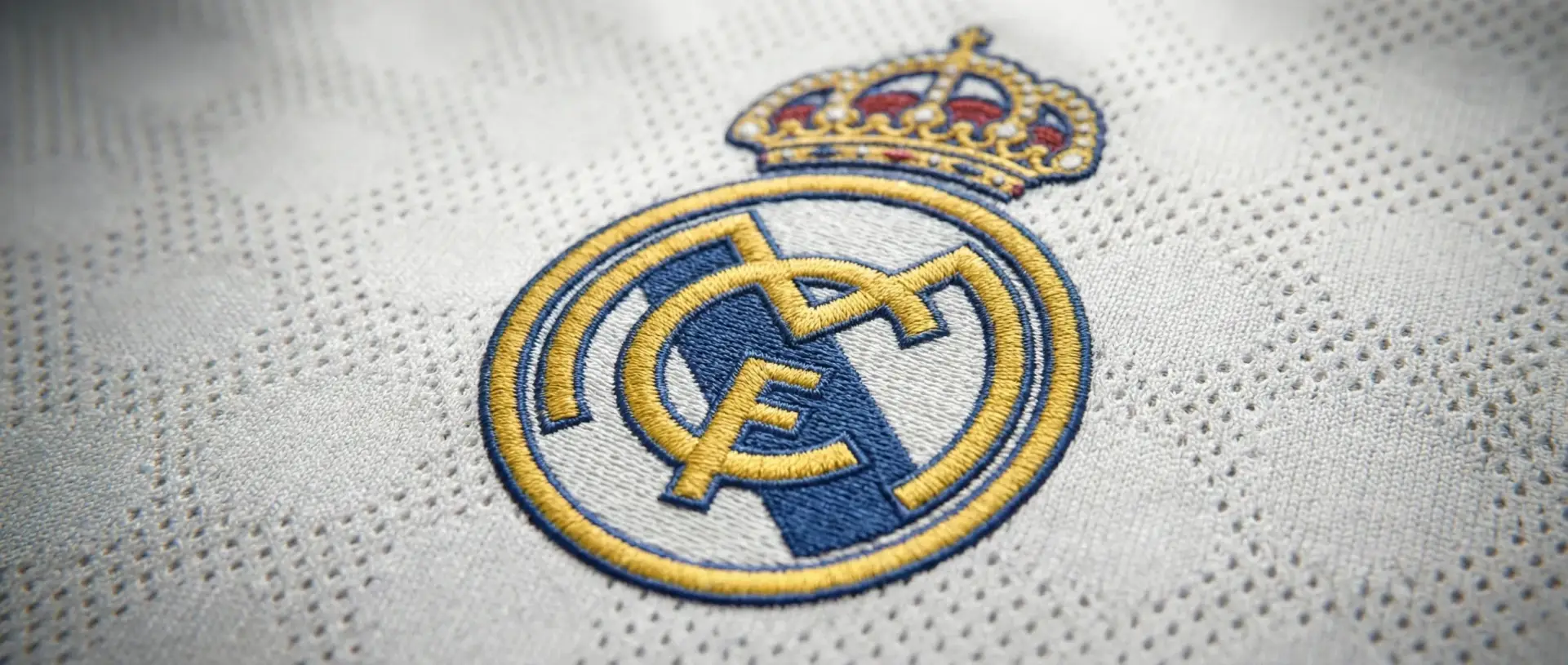 Premium Football Kit Manufacturer Macro shot of high-quality player version football kit manufacturer showing detailed embroidery and breathable mesh fabric for OEM custom orders.